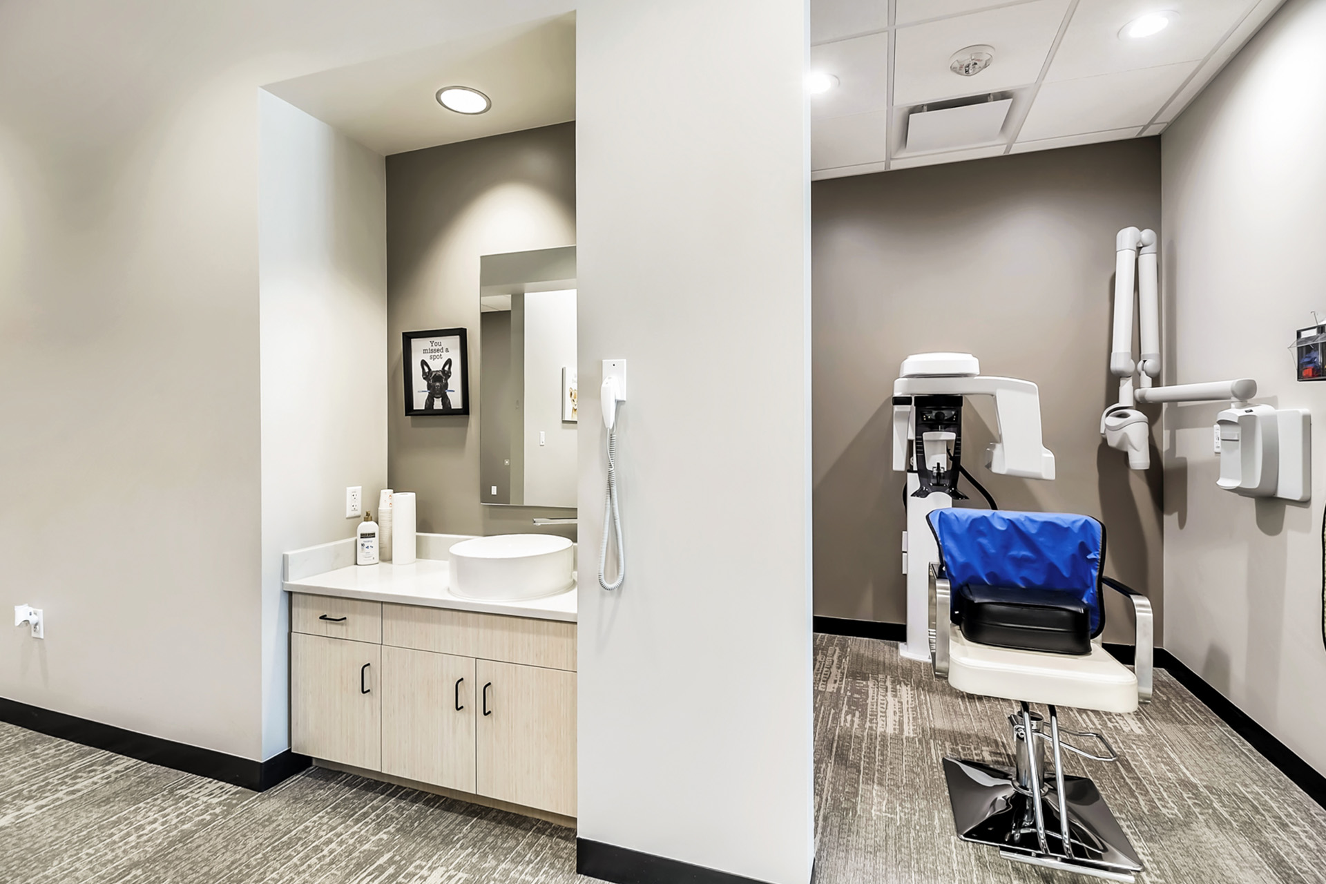 The image shows a modern dental clinic interior with a reception area, dental chairs, and a clean, well-lit environment.